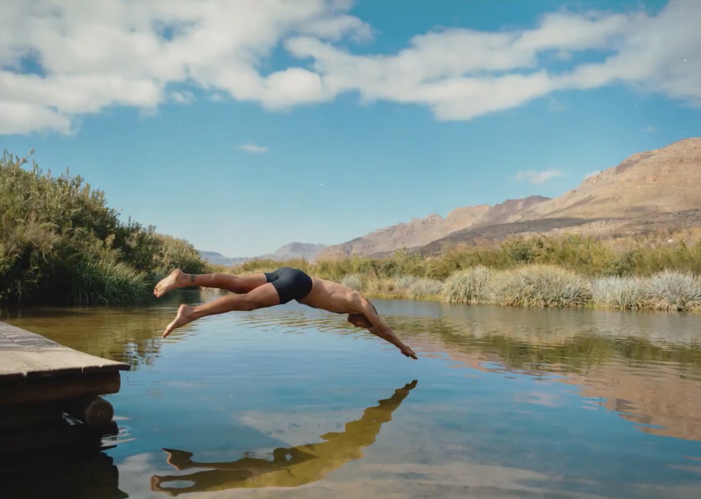 man diving into the river